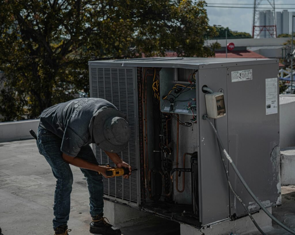 Man Drilling an Aircon Casing